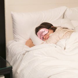 Top tips for better sleep - Woman asleep in bed with an eye mask on - Beds4us