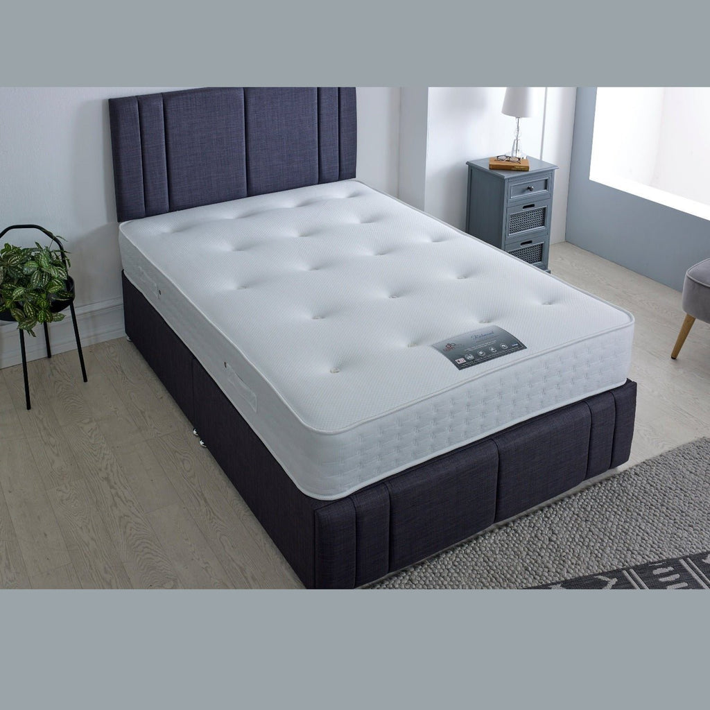 Dura Beds Richmond Gold 1000 Pocket Mattress - ON a blue base in a grey room, at a high angle - Beds4Us