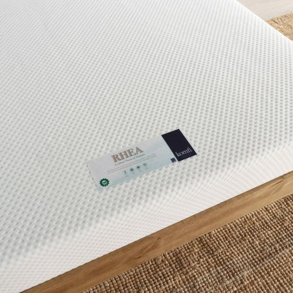 Komfi Rhea Carbon Neutral Deluxe Recycled Mattress - Mattress on a wooden bed frame close up of label - Beds4us