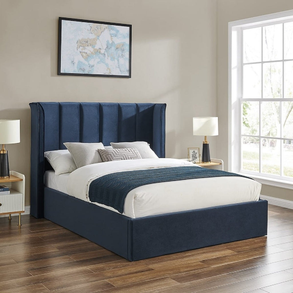 Allegra Velvet Curved Winged Headboard Ottoman Bed - Navy ottoman bed in a beige room - Beds4Us