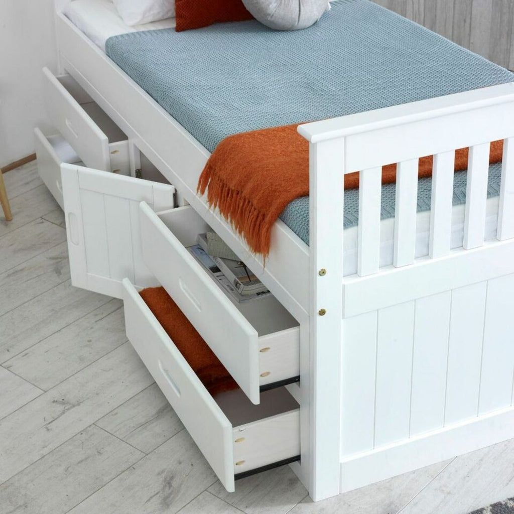 Captains Wooden Underbed Storage Bed - Close up of captain's bed in white, doors and drawers slightly open, positioned at an angle in a grey bedroom - Beds4Us