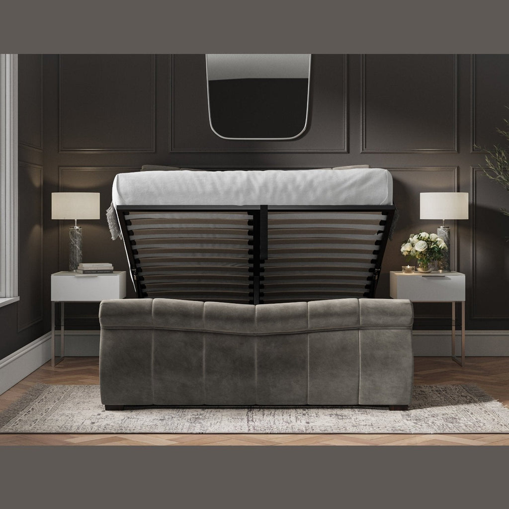 Bosworth Fabric Ottoman Storage Sleigh Bed  - Dark grey sleigh ottoman bed frame positioned face on, ottoman base lifted up, in a dark modern room - Beds4Us