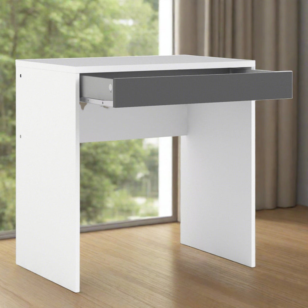 Compact Desk Table - White Desk with grey drawer, enlarged in a beige room in front of a large bright window - Beds4Us