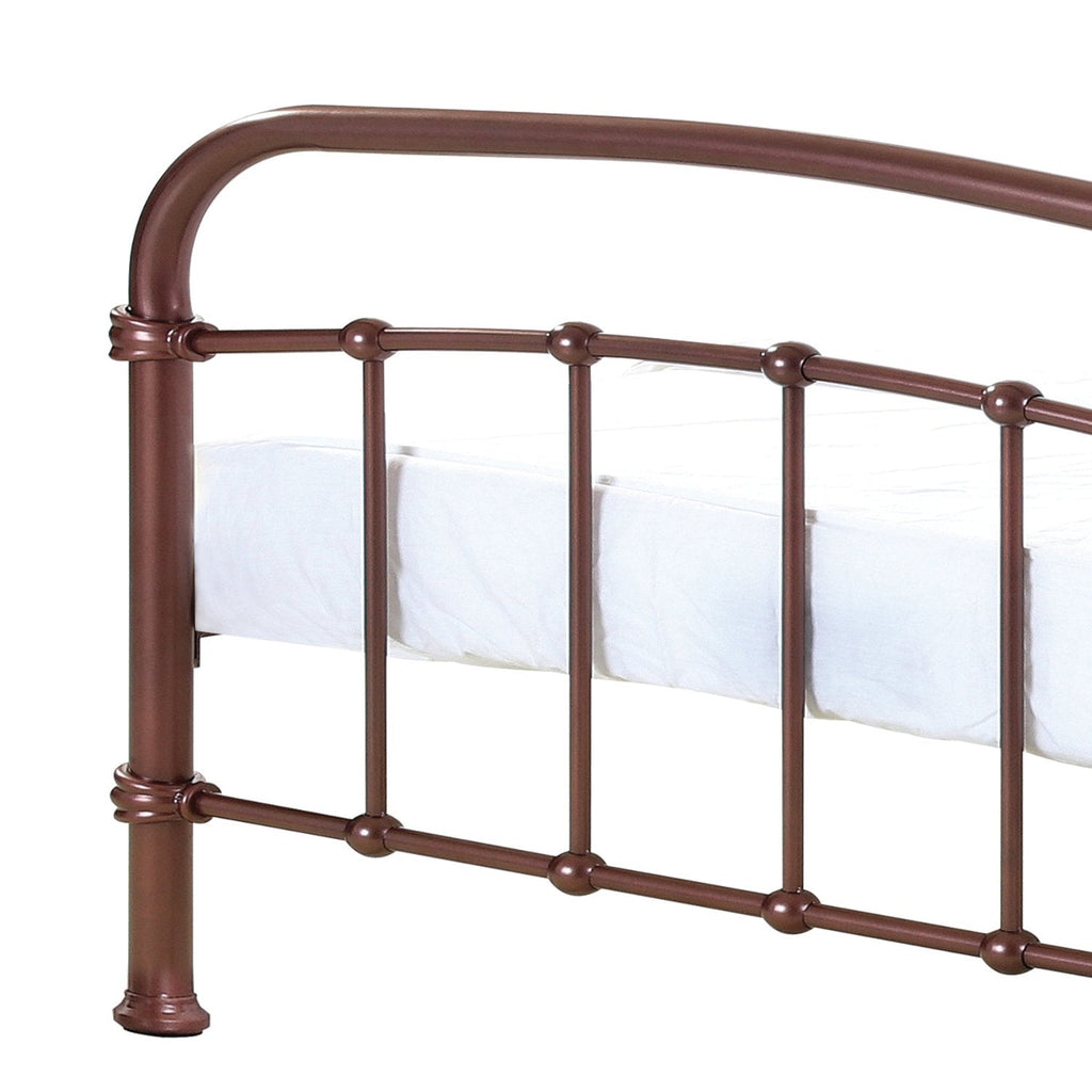 Halston Metal Bed Frame - Copper coloured metal bed frame with rounded headboard and footbaord and vertical bars, close up of footboard, positioned at an angle- Beds4Us
