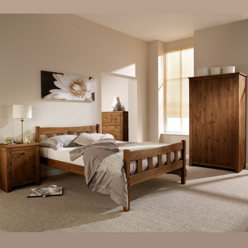 Havana Solid Wooden Bed Frame - Antique Pine waxed wooden bed frame with chunky vertical slatted headboard and matching footbaord, in a neutral modern bedroom, positioned at an angle- Beds4Us