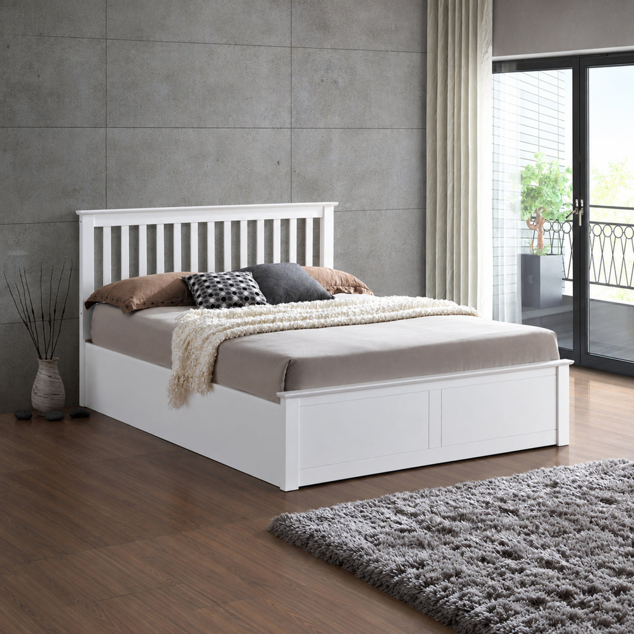 Malmo white wooden ottoman bed in a styled bedroom