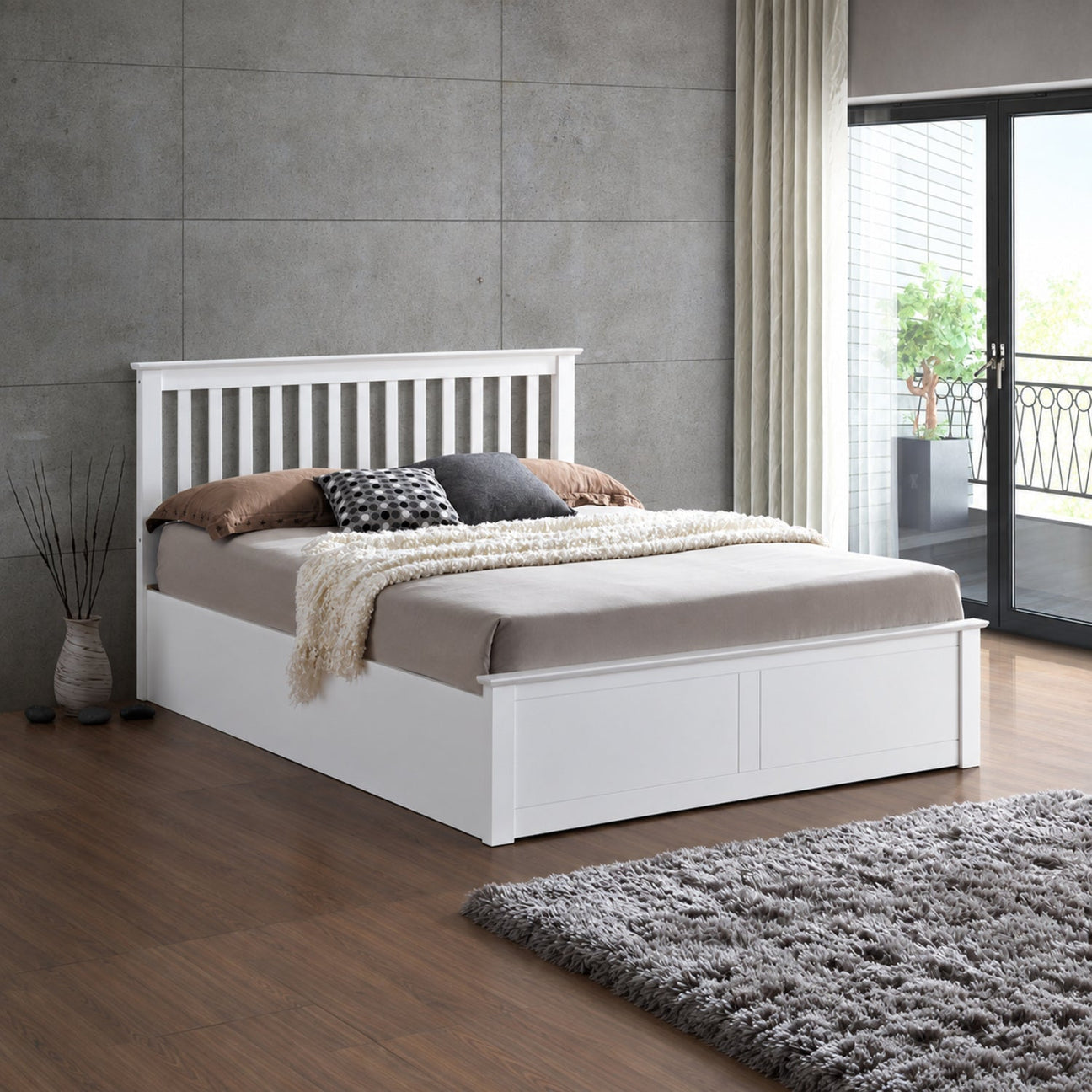 Malmo white wooden ottoman bed in a styled bedroom